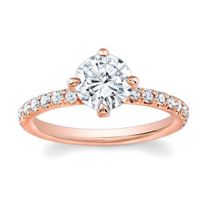 Round brilliant cut diamond engagement ring with compass prongs and pavé-set shoulders in rose gold.