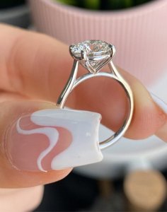 Cushion-cut diamond engagement ring in 14K white gold with a cathedral setting.